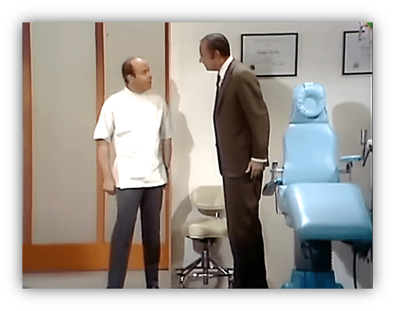 "Comedy scene featuring a dentist and patient in an office with dental chair."