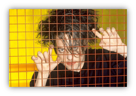 "Person with wild hair peering through a grid, vibrant yellow background."