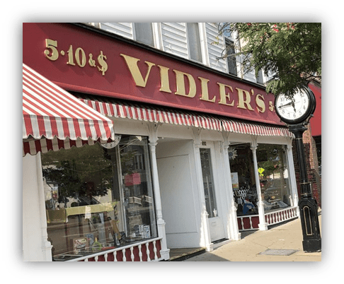 "Vidler's 5&10 store exterior with striped awning and clock."
