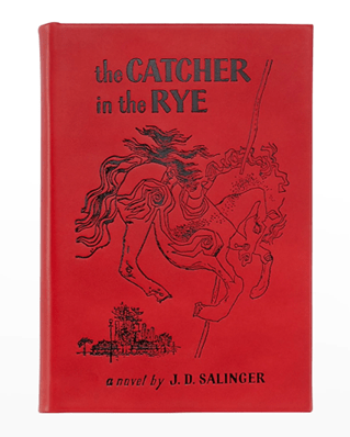 Alt text: "The Catcher in the Rye novel by J.D. Salinger with red cover and illustration of a carousel horse."