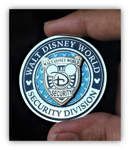 "Walt Disney World security badge held in hand, featuring iconic Mickey Mouse design."