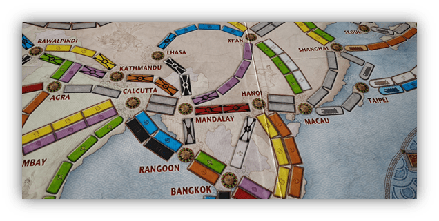 "Board game map featuring routes in Asia, including cities like Calcutta, Rangoon, and Bangkok."