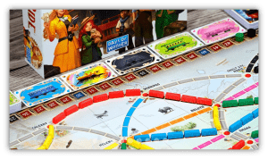 "Close-up of Ticket to Ride board game with colorful train pieces and destination cards."