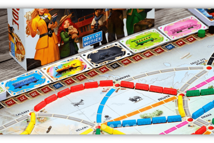 "Close-up of Ticket to Ride board game with colorful train pieces and destination cards."