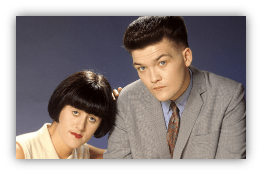 "Two characters in vintage fashion, posing closely against a blue background."