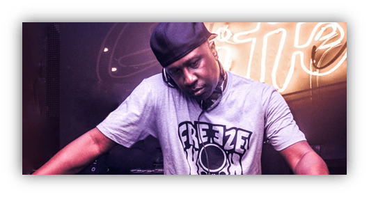 DJ performing at a nightclub, wearing a "Freeze" t-shirt.