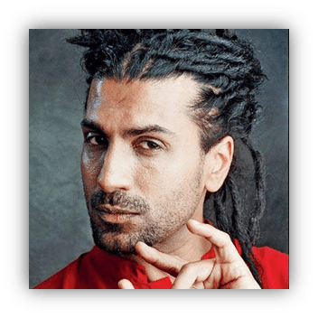 Portrait of a man with dreadlocks in a red shirt, showcasing a confident expression.