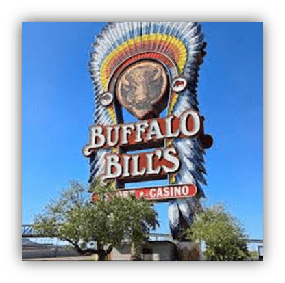 "Buffalo Bill's Casino sign with colorful Native American headdress against a blue sky."