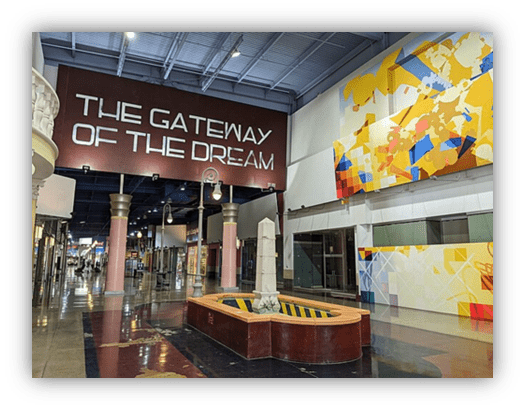 "Interior view of The Gateway of the Dream featuring a fountain and vibrant wall art."