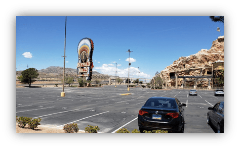 "Buffalo Bills Casino sign in a nearly empty parking lot under a clear blue sky."