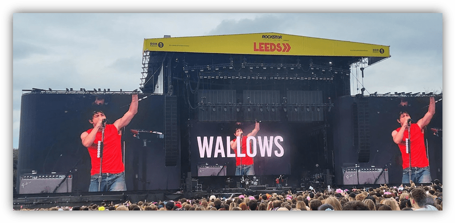 "Wallows performing live at Leeds Festival, with a large crowd and stage backdrop."