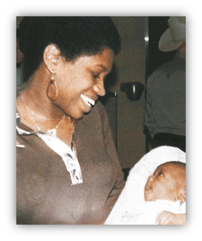 "Smiling woman holding a baby, showcasing a joyful moment of connection."