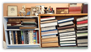 Bookshelves filled with various books, framed photos, and decorative items.