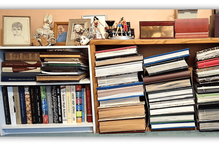 Bookshelves filled with various books, framed photos, and decorative items.