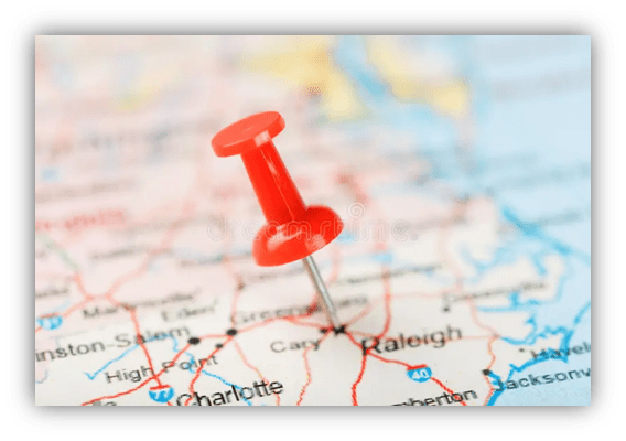 Red pushpin marking Raleigh on a map of North Carolina.