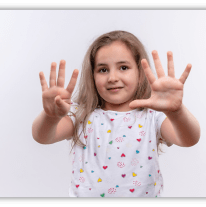 Young girl showing ten fingers, smiling against a white background.