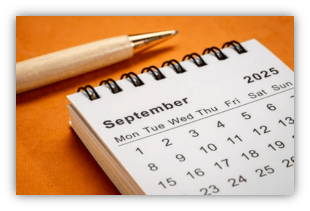 "September 2025 calendar page with a pen on an orange background."