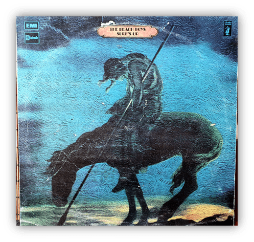 Album cover of "Surf's Up" by The Beach Boys featuring a silhouette of a figure on a horse against a blue background.