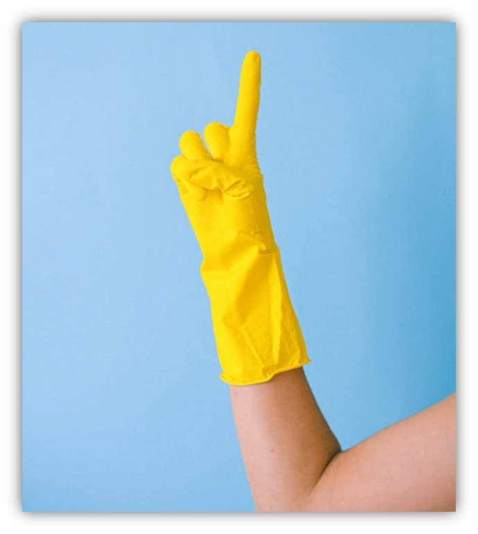 "Yellow rubber glove hand raised against a blue background."