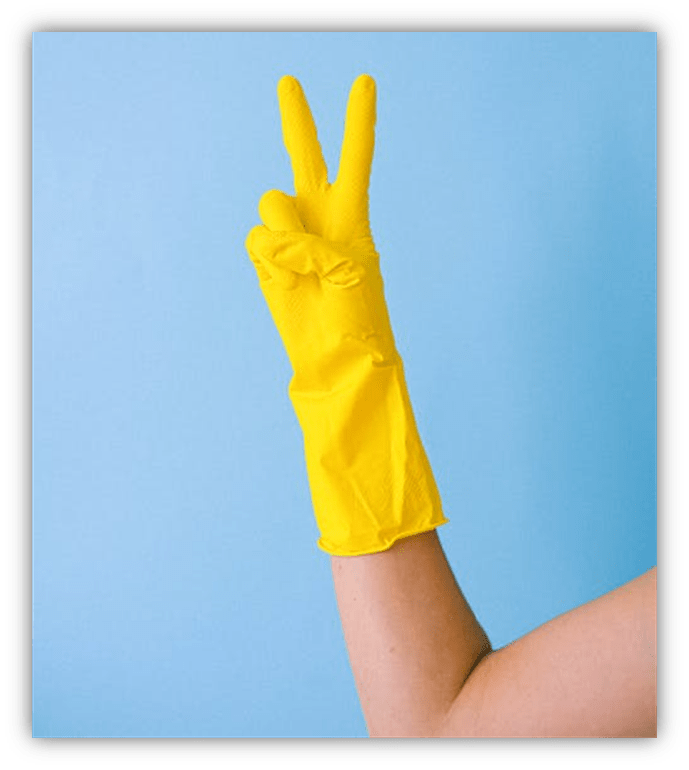 Yellow rubber glove hand making a peace sign against a blue background.