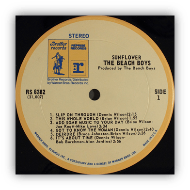 Alt text: "Vinyl record label for 'Sunflower' by The Beach Boys, featuring song titles and production details."