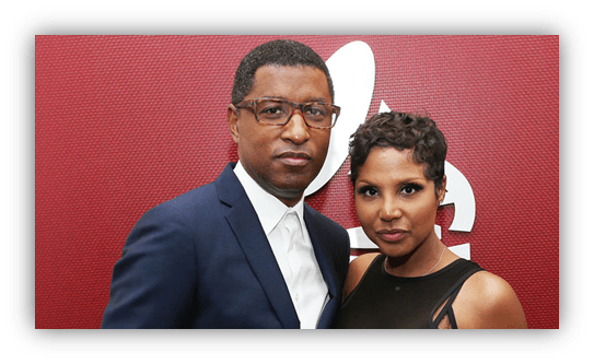 "Man and woman posing together at a red carpet event."