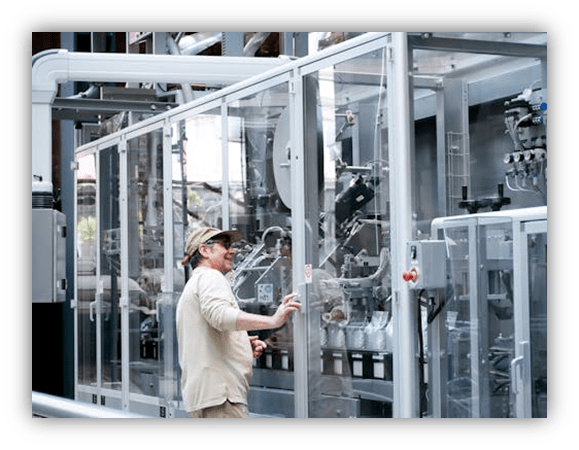 "Technician inspecting advanced machinery in a modern industrial facility."