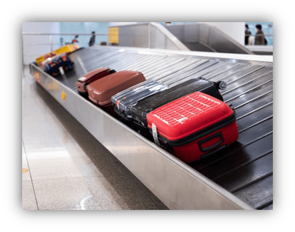 Luggage on an airport baggage claim conveyor belt.
