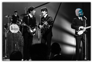 The Beatles performing live on stage in black and white.