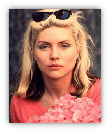 Blonde woman with sunglasses holding pink flowers, portrait.