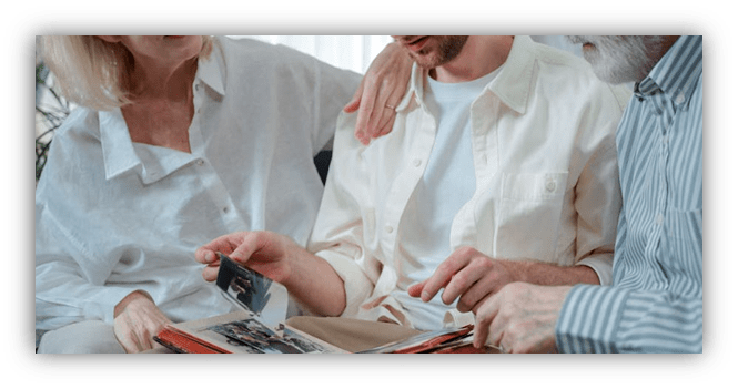 Family members sharing memories while looking through a photo album.