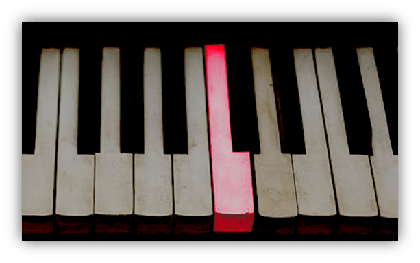 "Close-up of piano keys with one red key highlighted."