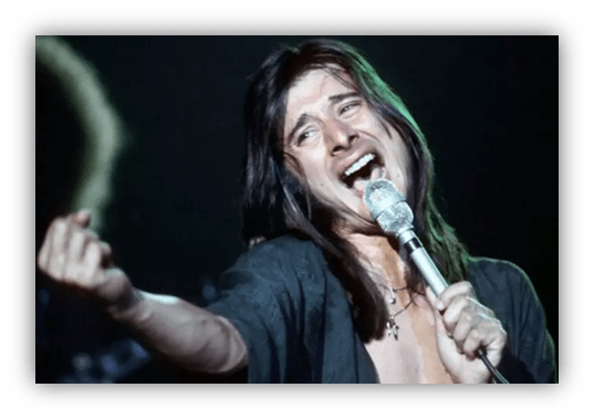 "Rock singer passionately performing on stage with a microphone."