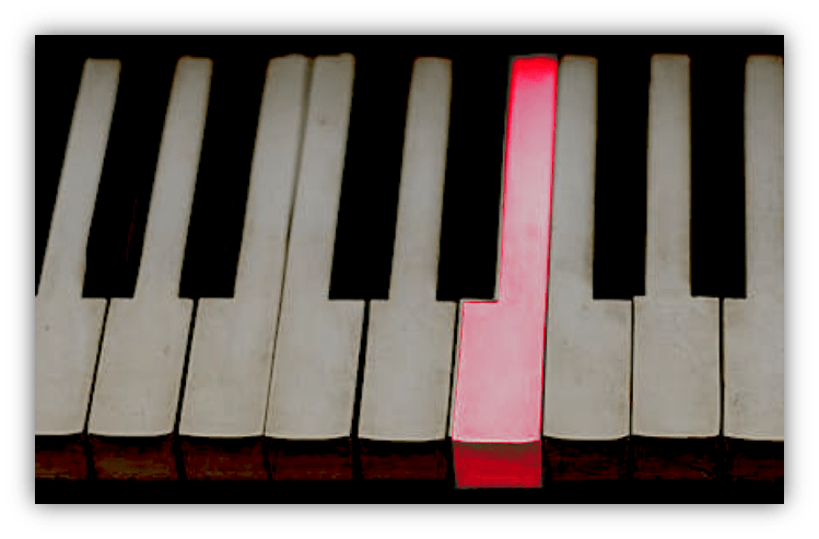 "Close-up of piano keys with one red key highlighted."