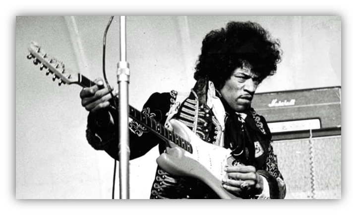 Jimi Hendrix performing on stage with electric guitar.