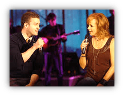 "Justin Timberlake and Reba McEntire performing together on stage."