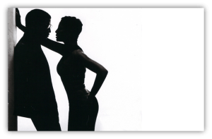 Silhouette of a couple in an intimate pose against a white background.