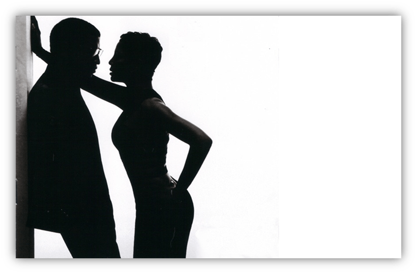 Silhouette of a couple in an intimate pose against a white background.