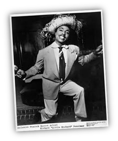 "Richard 'Little Richard' Penniman in a stylish suit and hat, performing joyfully."