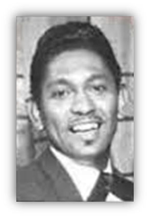 "Smiling man in a suit, black and white portrait."