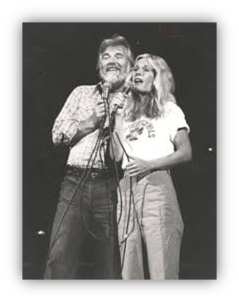 "Vintage black and white photo of two singers performing on stage."