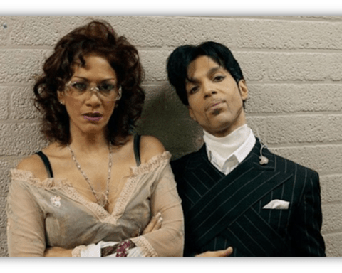 "Two individuals posing together against a textured wall, showcasing unique fashion styles."