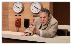 "Angry news anchor gesturing in a studio with clocks for Tokyo and Los Angeles in the background."