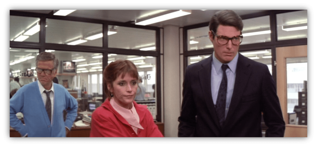 Three office workers in a newsroom, displaying concern and contemplation.