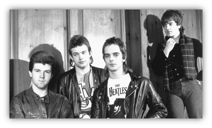 "Four musicians in leather jackets posing against a wooden backdrop, capturing a vintage rock band vibe."