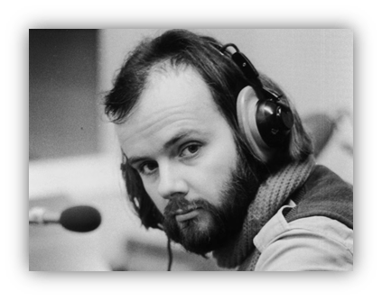 "Man with headphones in a vintage studio setting, focused and engaged."