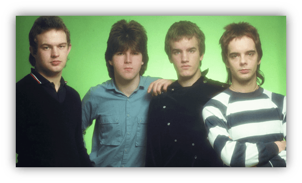 "Four young men posing against a green background, showcasing 1980s fashion."