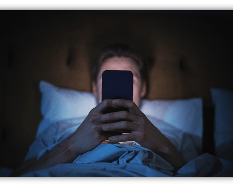 Person in bed using a smartphone at night.