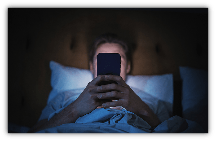Person in bed using a smartphone at night.