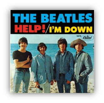 "The Beatles 'Help! I'm Down' album cover featuring the band on a beach."